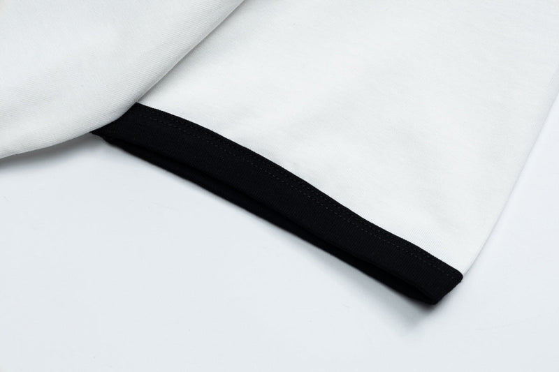 White ringer tee with black trim and folded sleeve detail, showcasing a clean retro Y2K streetwear style