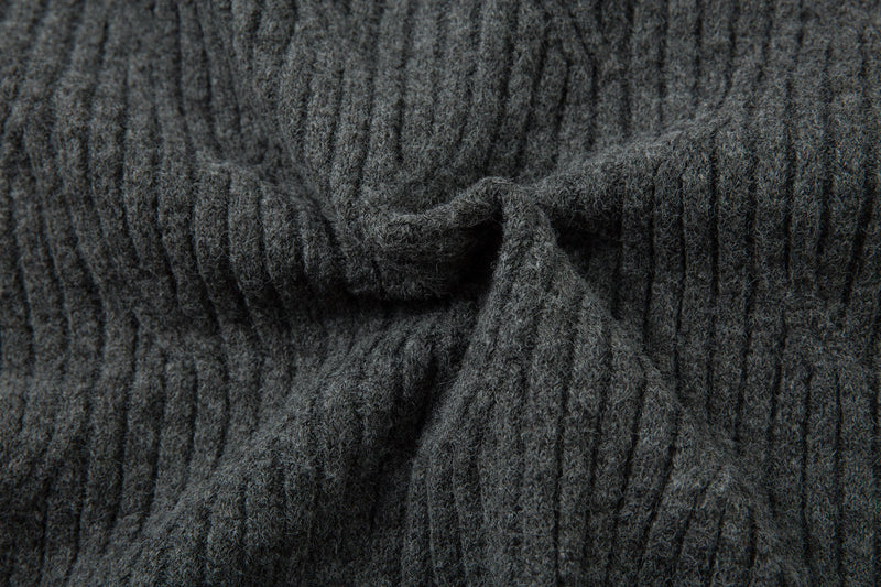 Close-up of charcoal gray sweater neckline with tied front detail