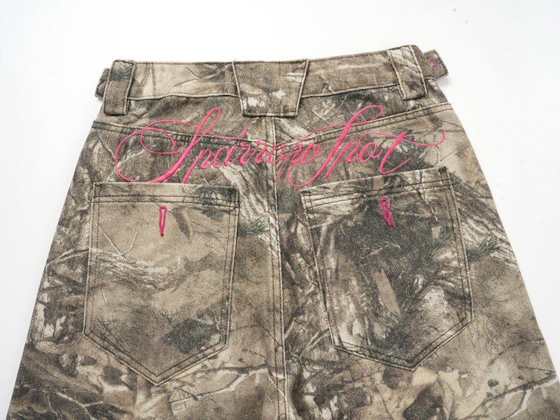 Upper back of forest camo wide-leg pants with pink embroidery and rear pockets