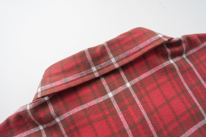 Close-up of red plaid flannel shirt collar and upper shoulder seam