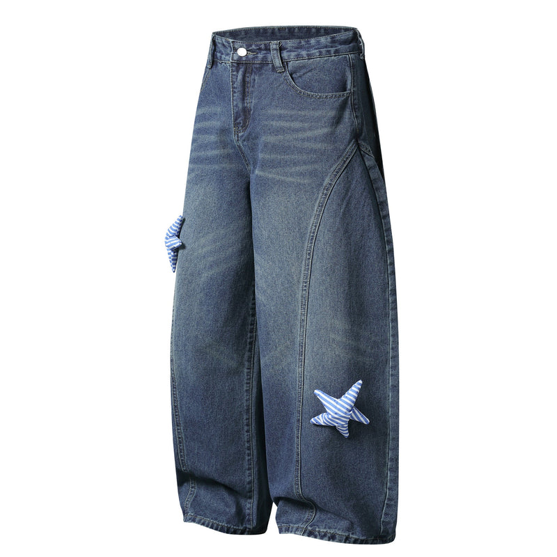 Blue wide-leg jeans with striped star patches on the leg, angled front view
