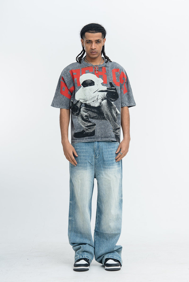 Oversized vintage-wash graphic tee with bold red lettering and distressed black-and-gray streetwear print on model