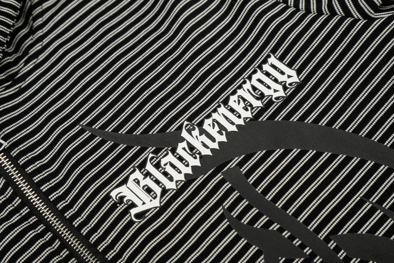 Close-up of front graphic across black striped zip hoodie