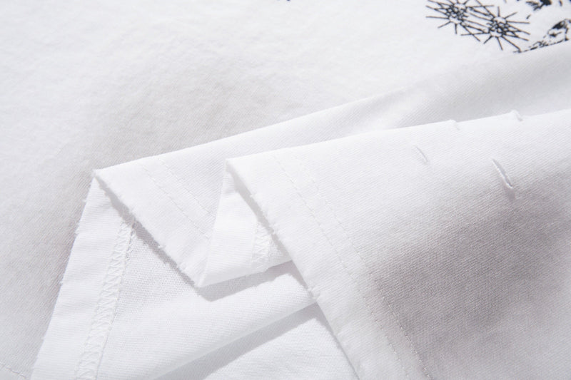 White oversized graphic T-shirt with folded sleeves and subtle distressed print detail