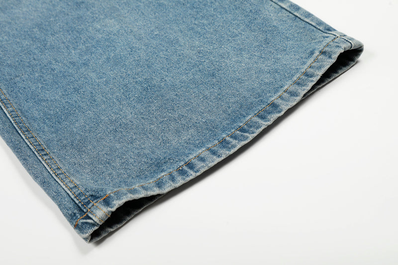 Cuffed hem close-up of blue wide-leg denim jeans