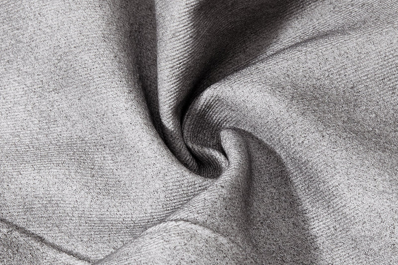 Close-up of gray washed denim fabric texture with soft wrinkled finish
