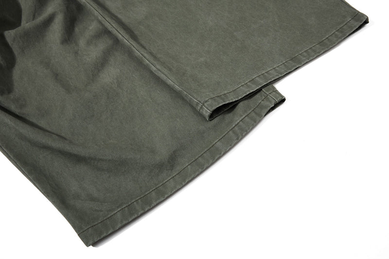 Close-up of olive green pant cuff and hem stitching