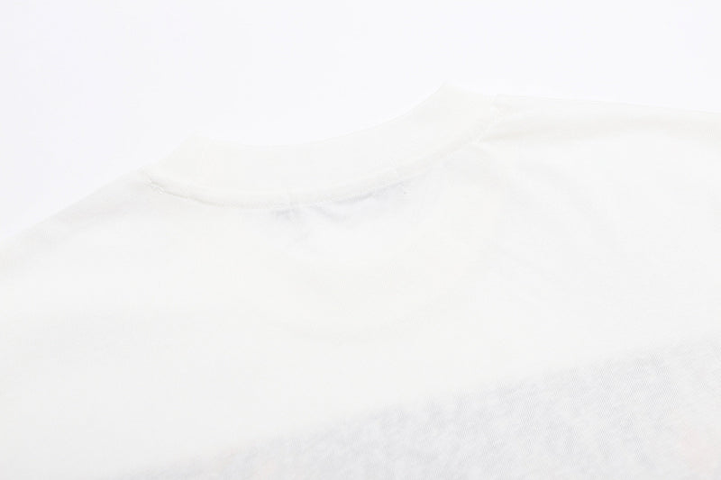 White vintage graphic T-shirt laid flat, showing a crew neckline and soft cotton fabric texture in a clean studio shot