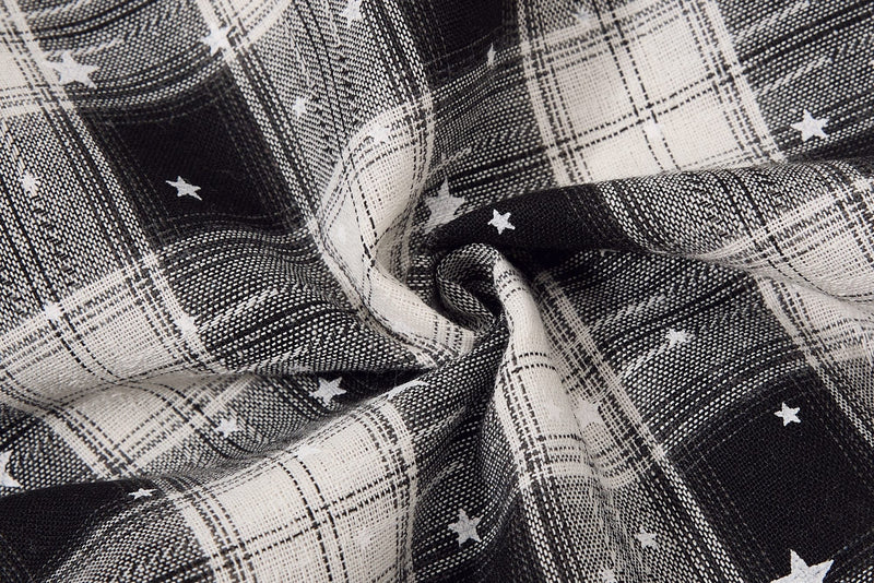 Close-up of gathered plaid fabric on black and white star print shorts