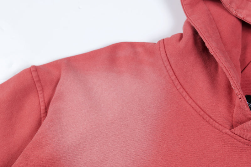 Close-up of red hoodie shoulder and upper sleeve seam