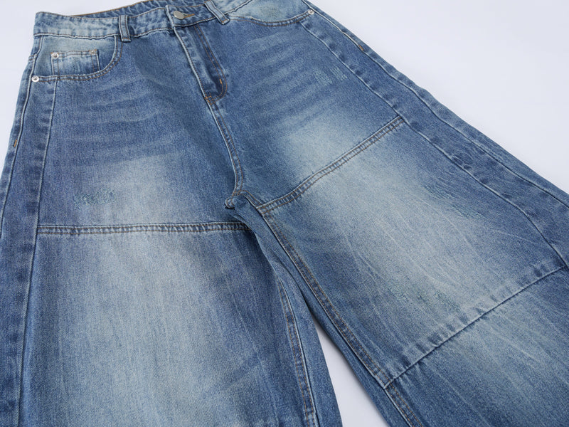 Front view of barrel leg jeans showing wide legs, faded wash, and patch pockets