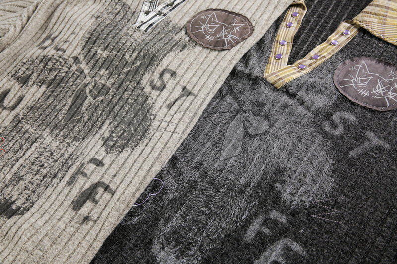 Close-up of beige and black sweater fronts with bear graphics, plaid trims, and snap necks