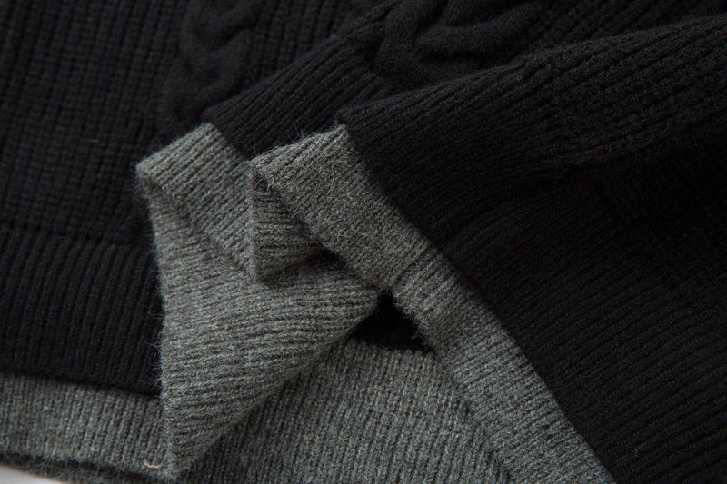 Close-up of black and gray ribbed cuffs on cable knit sweater