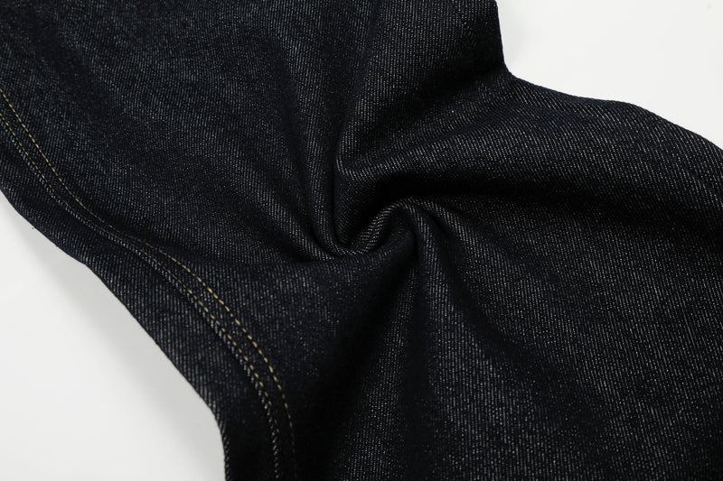 Close-up of dark wash denim leg fabric and seam stitching