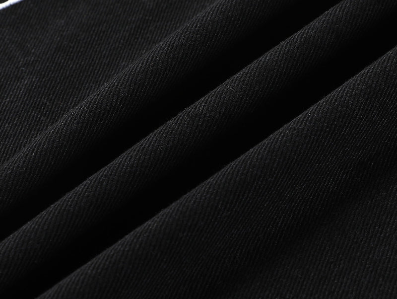 Close-up of black denim fabric texture and fold detail