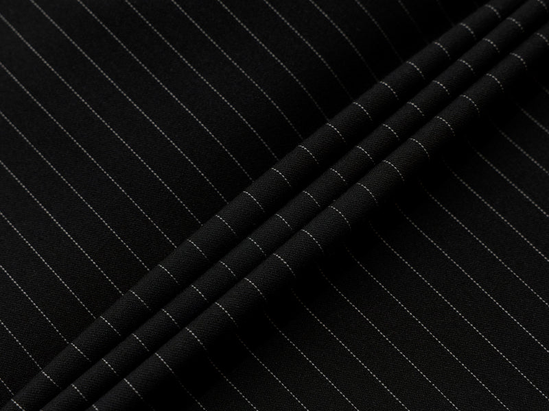 Macro close-up of black fabric with thin white pinstripes and soft folds