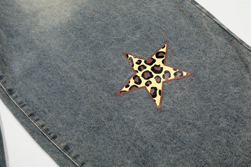 Close-up of single leopard print star patch on blue denim jeans