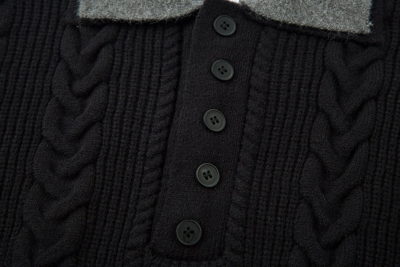 Close-up of black polo placket with gray collar and three buttons