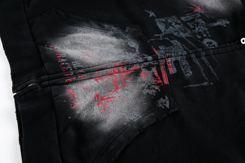 Close-up of front kangaroo pocket and printed graphic on washed black hoodie