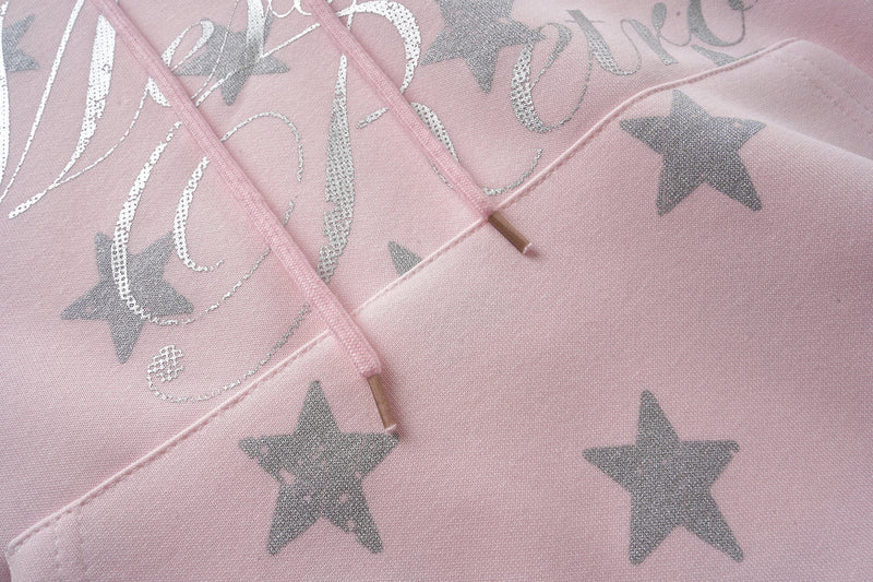 Pink hoodie front close-up showing glitter script and drawstrings