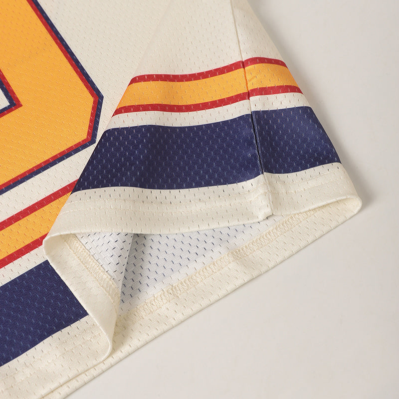 Vintage 69 football jersey sleeve with cream mesh fabric, navy and red stripe accents, and retro yellow detailing