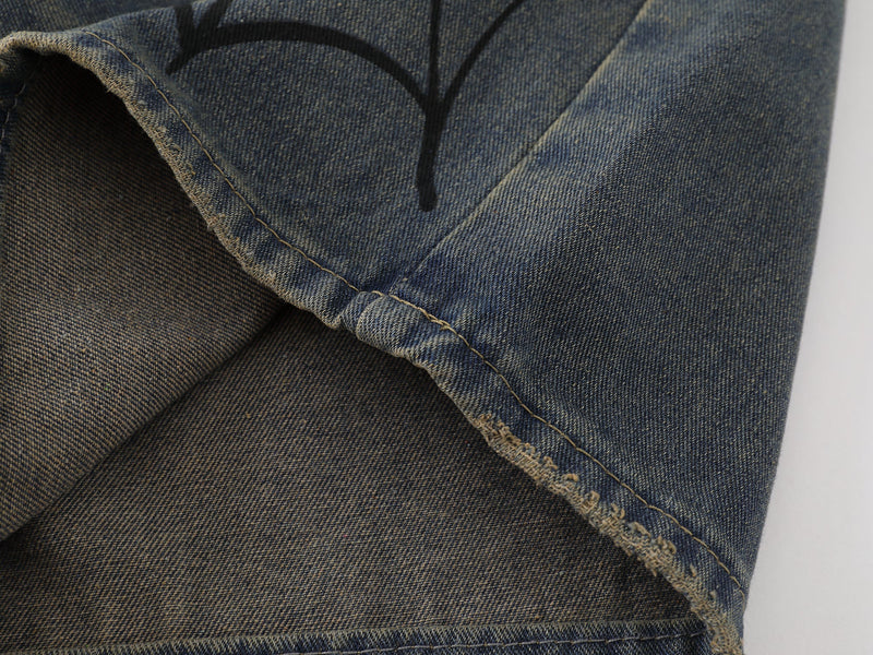 Close-up of hem and side seam on wide-leg blue denim shorts