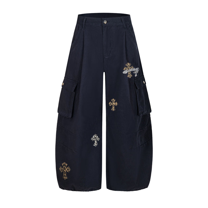 Black wide-leg cargo pants with leopard cross patches and side flap pockets