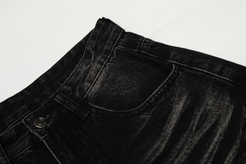 Close-up of black jeans waist and front pocket seam