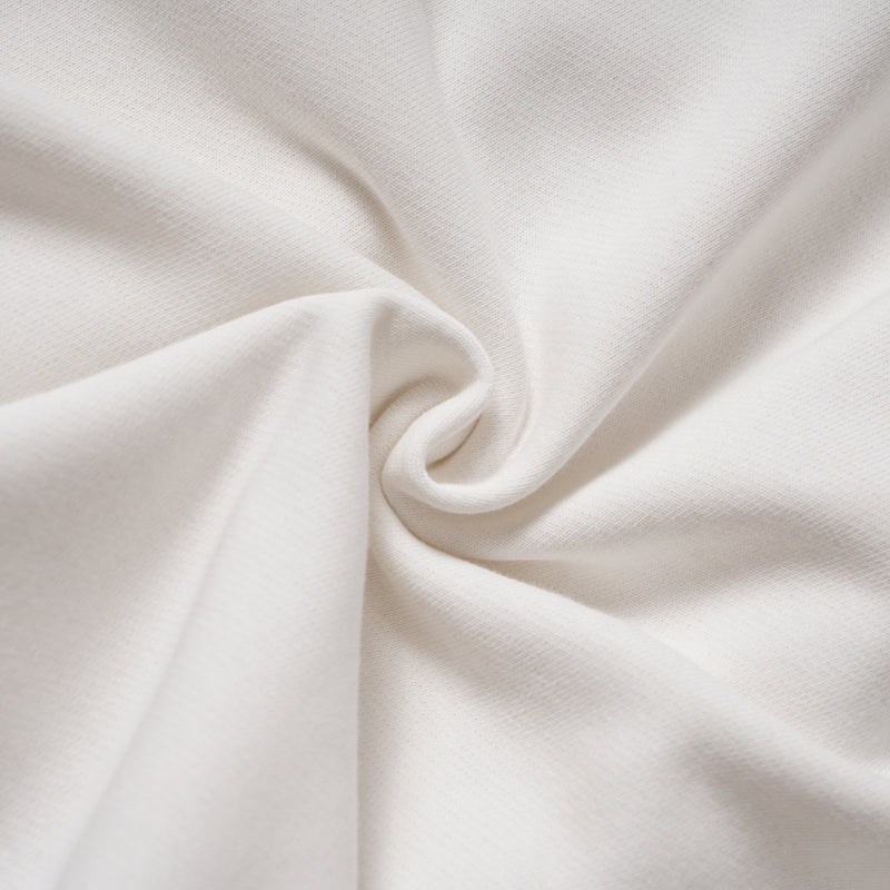 Close-up of white hoodie fabric gathered into soft folds