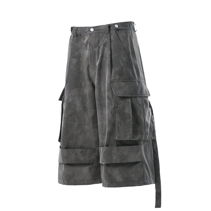Angled side view of black mesh cargo shorts with large flap pocket and hanging strap