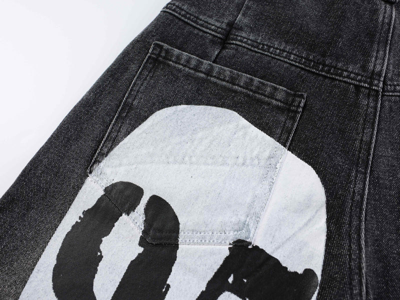Close-up of black denim back pocket with white graphic print