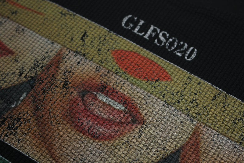 Close-up of a black streetwear tee with distressed collage lip graphic and Seakoff text print