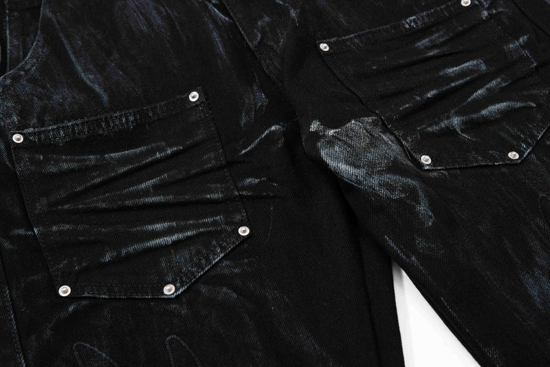Close-up of black cargo pockets with silver rivets and washed finish