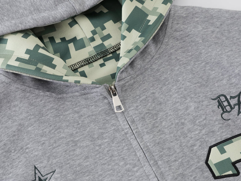 Close-up of gray hoodie zipper and camouflage hood lining