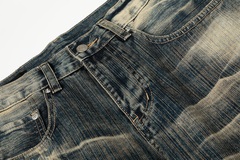 Close-up of the front pocket and waistband on vintage washed denim pants