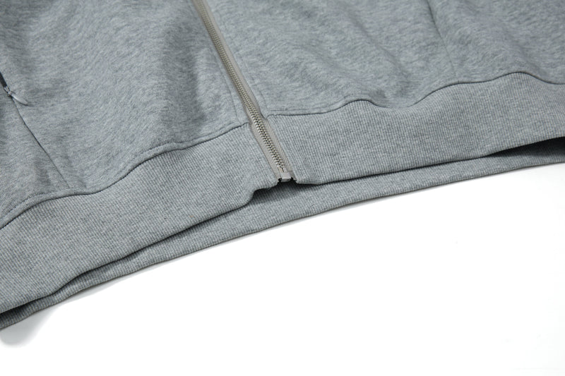 Close-up of gray hoodie hem and bottom zipper