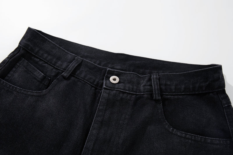 Close-up of the waistband with button closure and belt loops