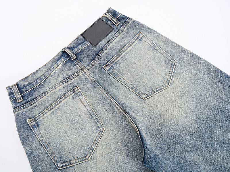 Close-up of back waistband and patch pockets on washed blue denim jeans