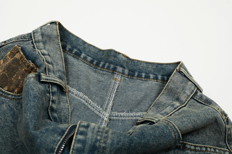 Close-up of denim waistband and inner seam stitching on blue jeans