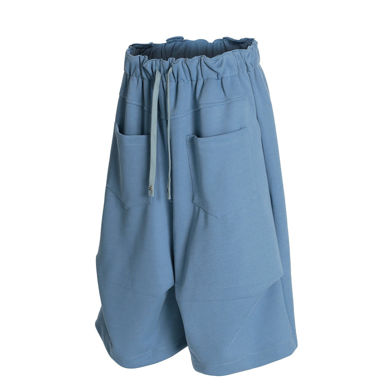 Blue wide-leg shorts angled front view with drawstring and patch pockets
