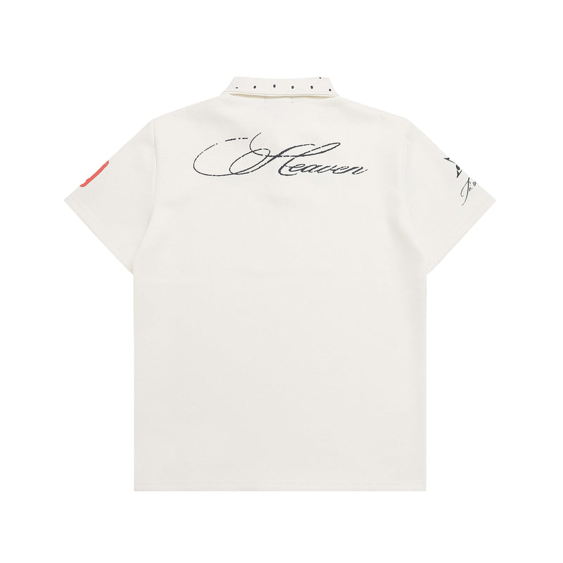 White graphic polo shirt with studded collar, script back print, and short sleeves on a clean background