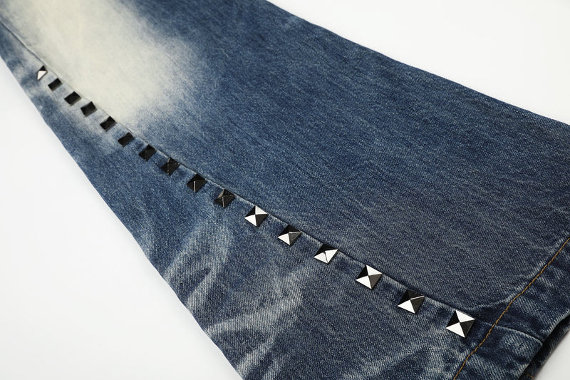 Close-up of side seam studs on blue vintage wash denim leg
