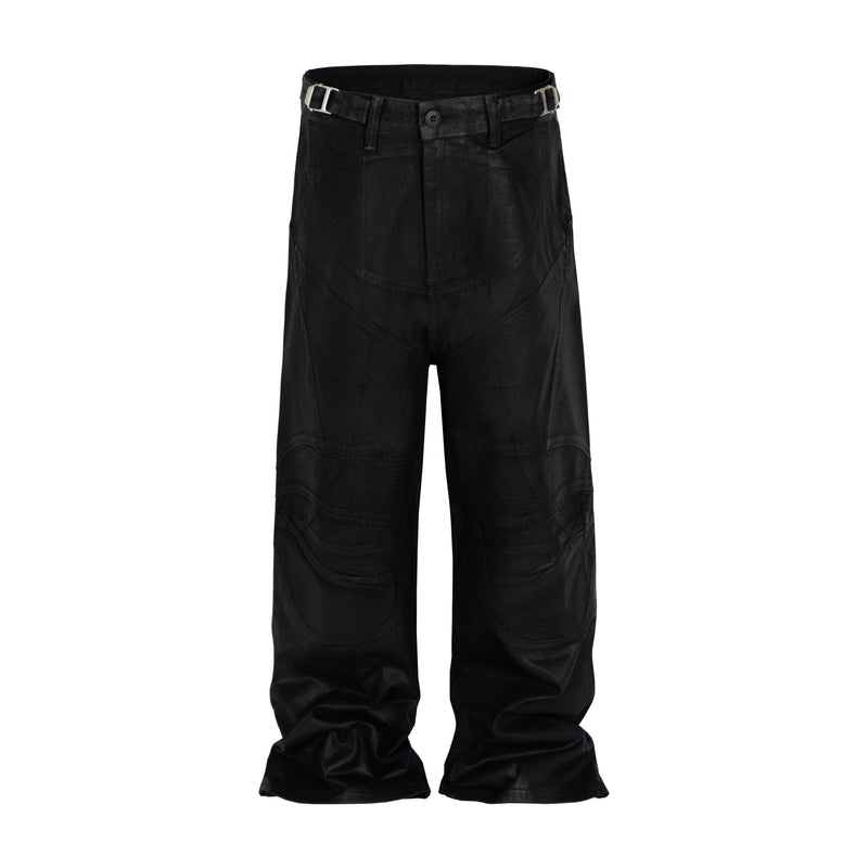 Black wide-leg pants with curved stitching, front view with belt straps and buckle details