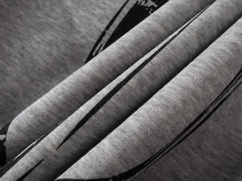 Close-up of gray hoodie print with black gothic lettering and decorative artwork
