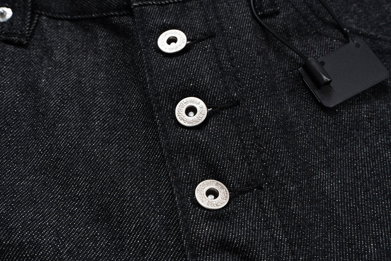 Close-up of the button fly with silver buttons and hanging tag