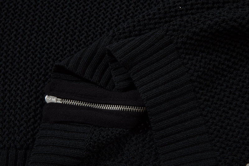 Black zipper and ribbed cuff detail on mesh knit jacket close-up