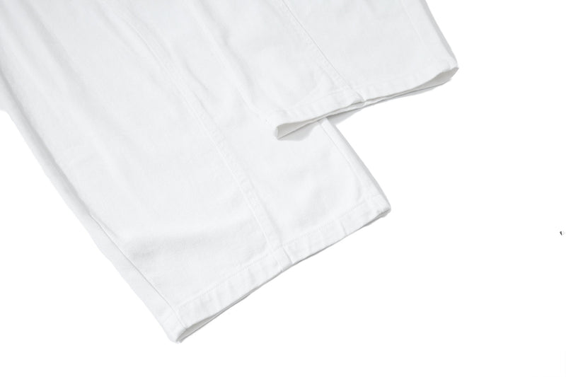 Close-up of white pant hem with stitched cuff detail