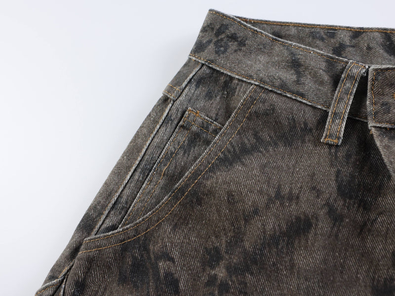 Close-up of front pocket and waistband on dark mottled wide leg jeans
