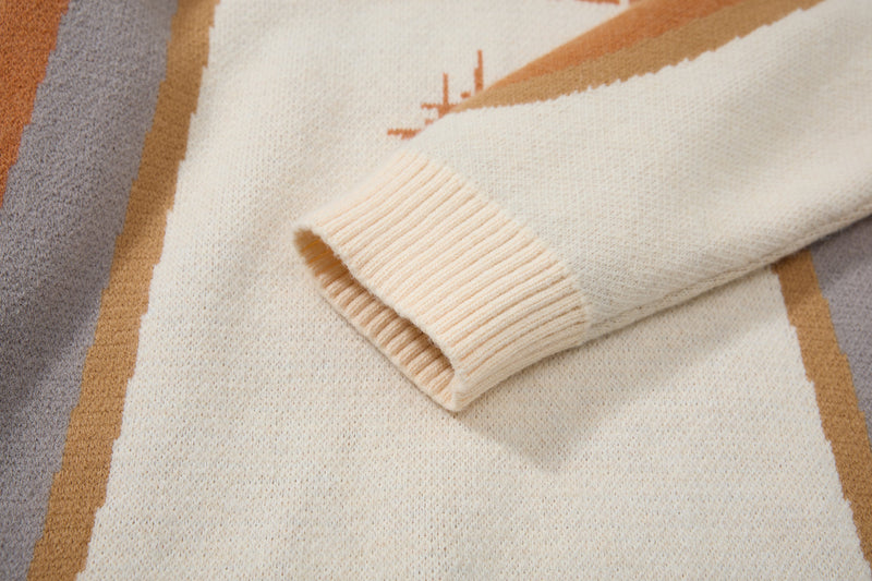 Close-up of cuff on cream knit sweater with tan and gray colorblock stripes