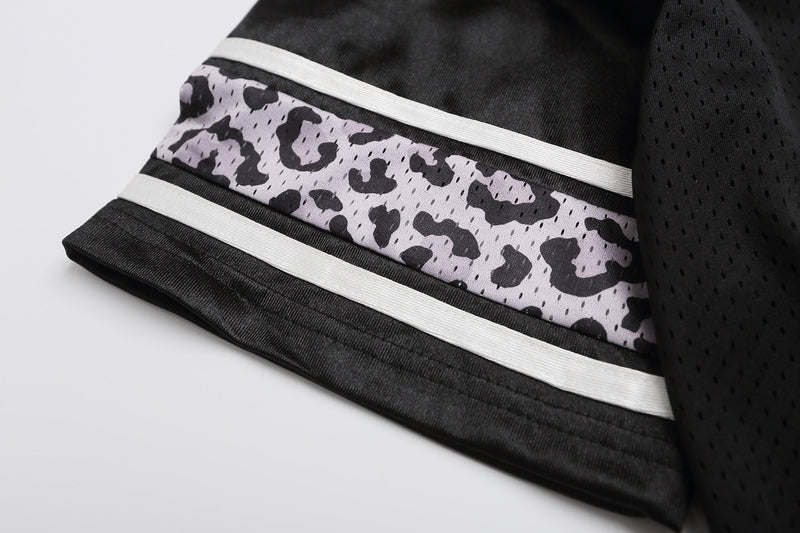 Black varsity football jersey T-shirt sleeve with white stripes and gray camouflage panel close-up
